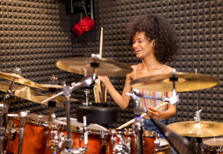 Young woman playing the drums